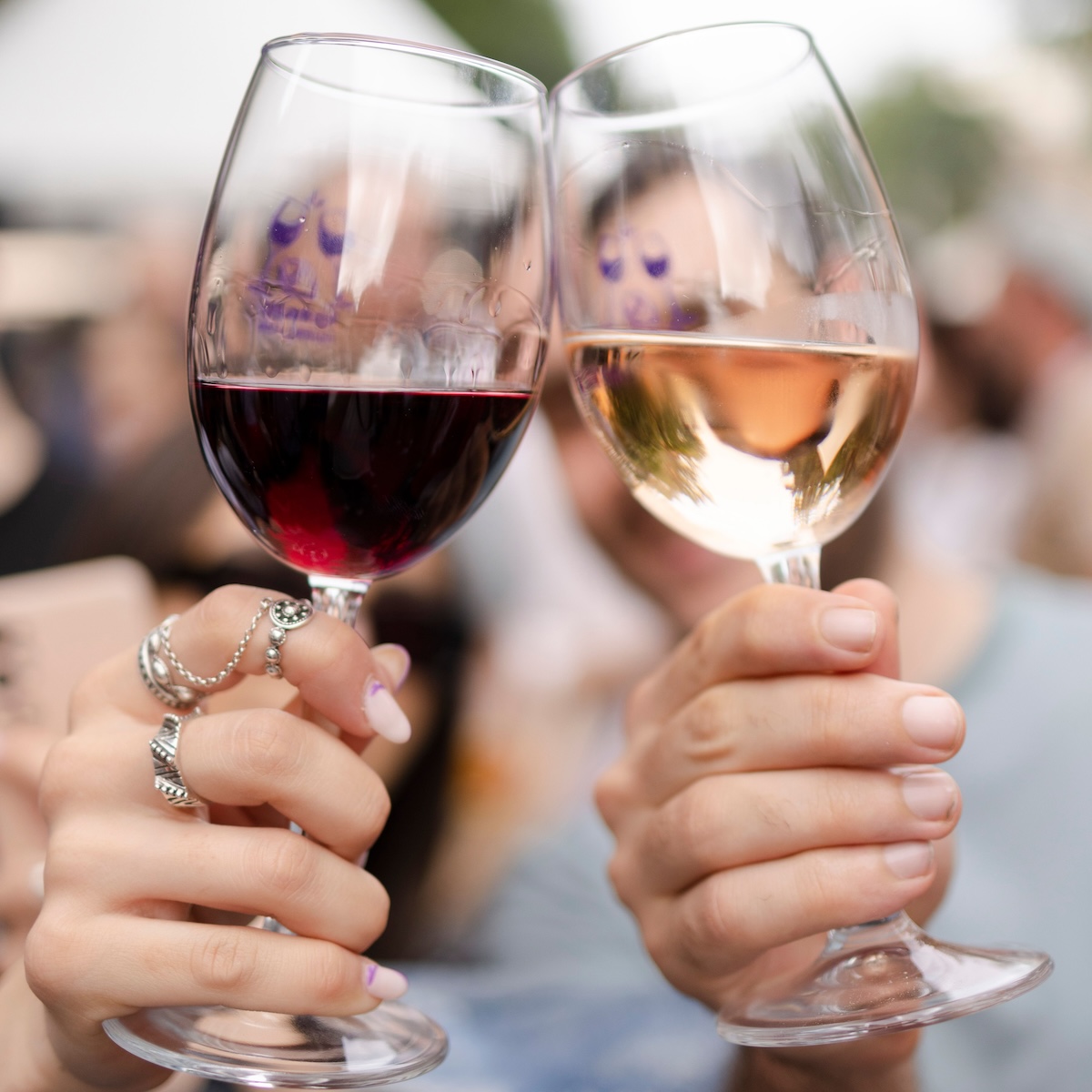 A vertical shot of people holding wine glasses